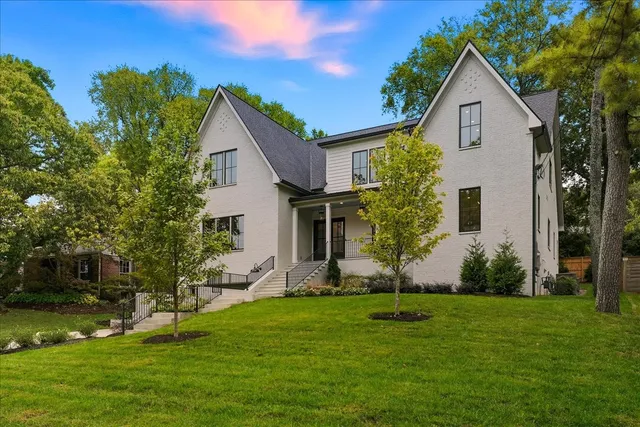 a front view of house with yard and green space