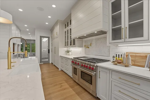 a bathroom with a double vanity sink mirror and bathtub
