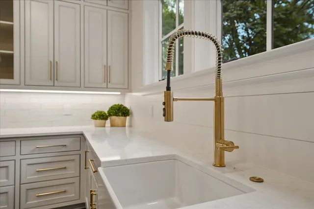 a kitchen with stainless steel appliances kitchen island granite countertop a table and chairs in it