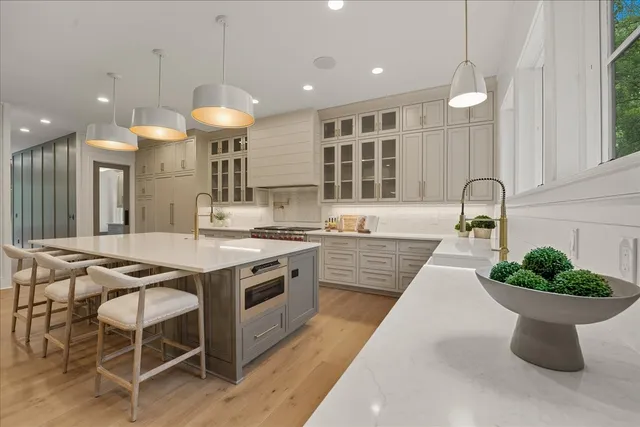 a kitchen with stainless steel appliances granite countertop a sink and cabinets
