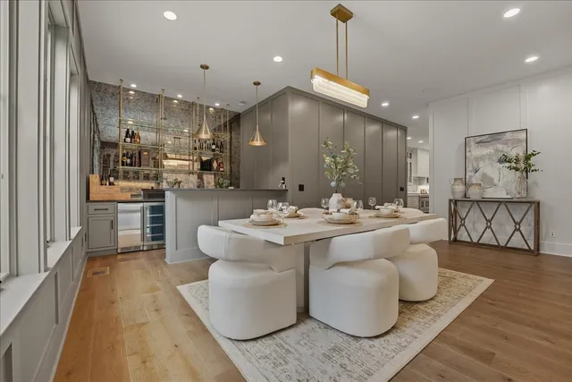 a spacious bedroom with a bed a couch and large window