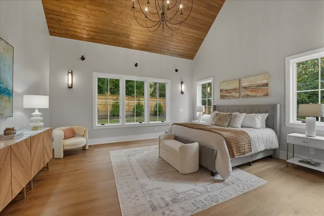 an empty room with windows and a ceiling fan