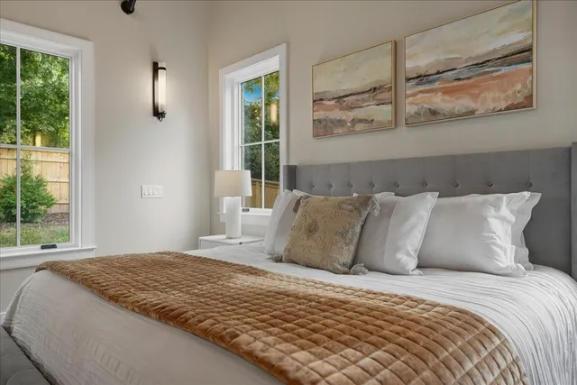 a bathroom with a granite countertop sink a toilet and a window