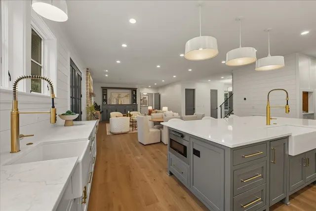 a bathroom with a glass door shower a sink and a mirror