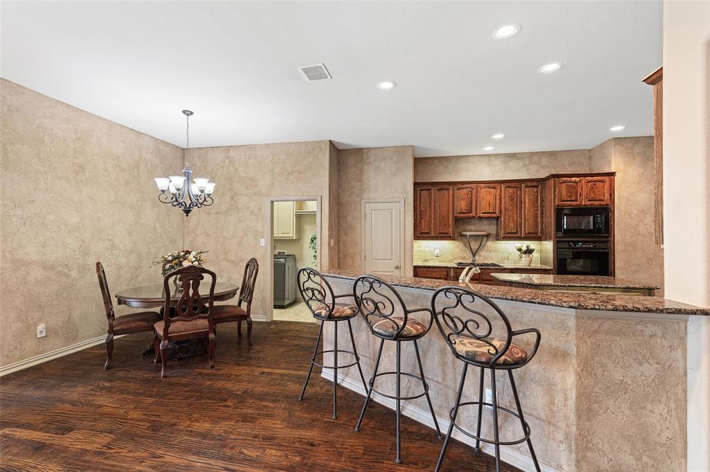 1217 Windmere Way Allen, TX 75013 - Photo 17 of 38 Designed for connection, the open breakfast area and expansive serving bar make everyday living feel warm and inviting.