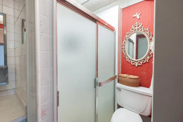a bathroom with a toilet and a shower curtain