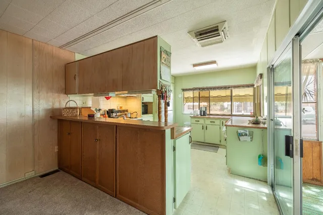 a kitchen with lots of counter space and windows
