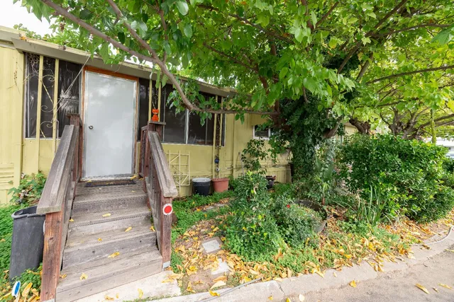 a front view of a house with a garden