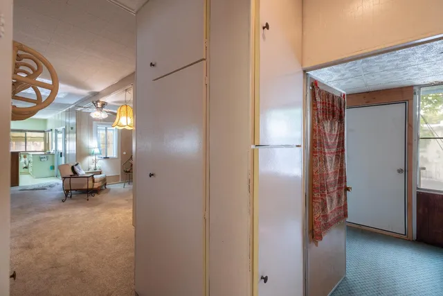 a view of hallway with livingroom and furniture