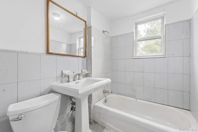a kitchen with granite countertop a stove a sink and a window