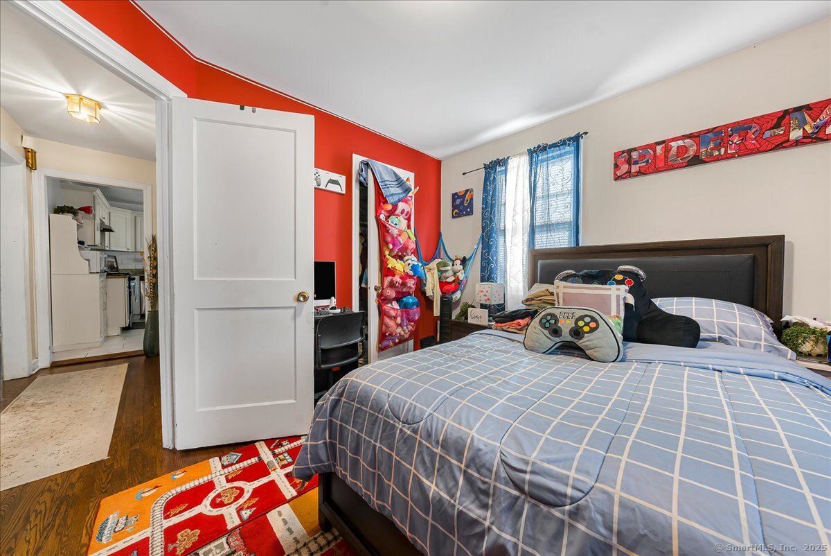 631 Fairview Avenue Bridgeport, CT 06606 - Photo 12 of 22 a bed room with a bed and a chair