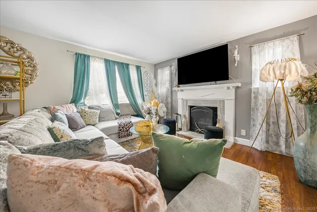 a living room with furniture fireplace and flat screen tv