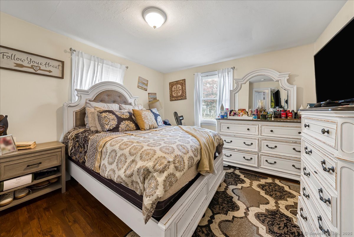 631 Fairview Avenue Bridgeport, CT 06606 - Photo 8 of 22 a bedroom with a bed and a flat tv screen on dresser