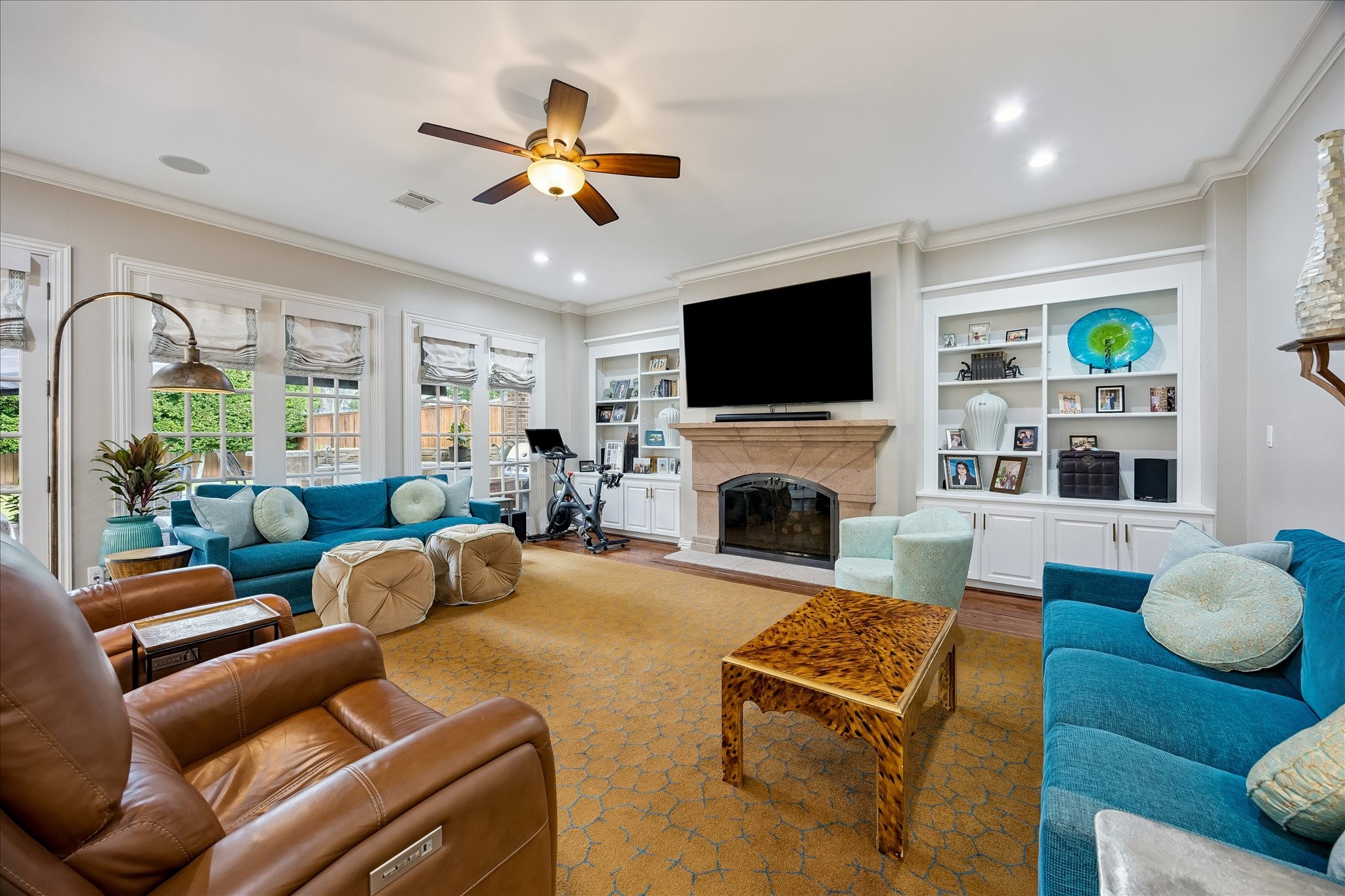 6358 Auden Street Houston, TX 77005 - Photo 11 of 50 a living room with furniture a fireplace and a flat screen tv