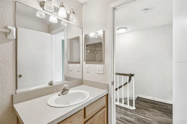 a bathroom with a sink a mirror and a shower