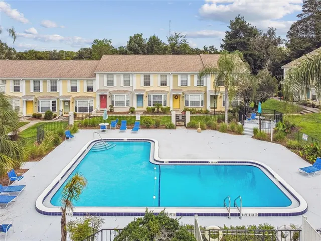 a view of swimming pool with outdoor seating and plants