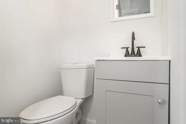 a white toilet sitting next to a bathroom sink