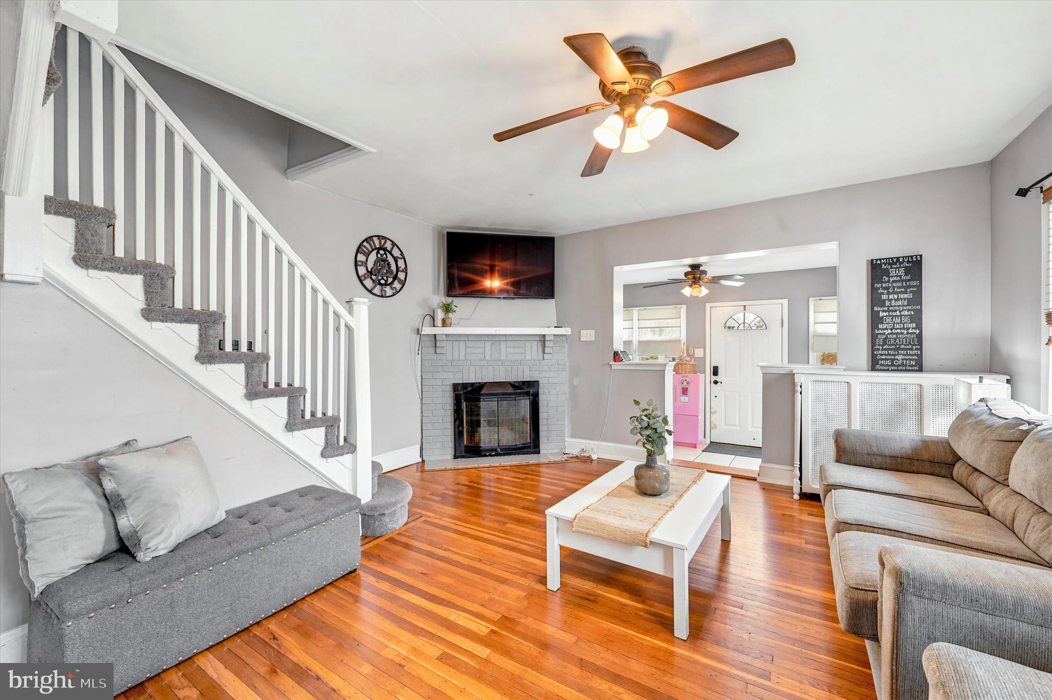 1210 Harding Drive Havertown, PA 19083 - Photo 3 of 25 a living room with fireplace furniture and a wooden floor