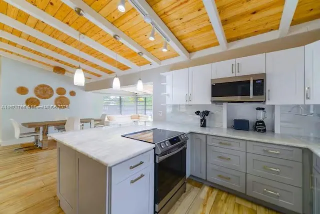 a kitchen with a sink stove and microwave