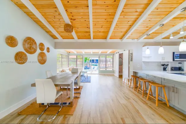 a view of a dining room with furniture and a window