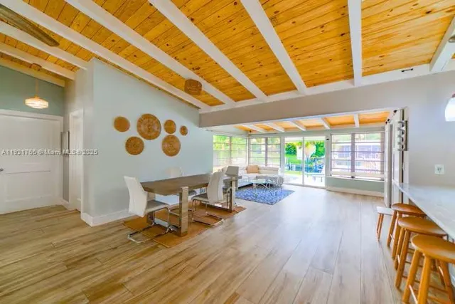 a view of a room with wooden floor and furniture