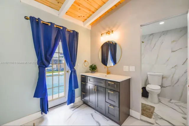 a view of bathroom with a sink mirror vanity and toilet