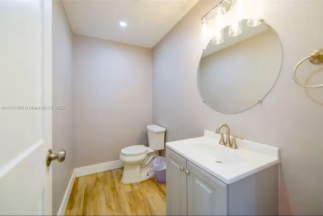 a bathroom with a sink mirror and toilet