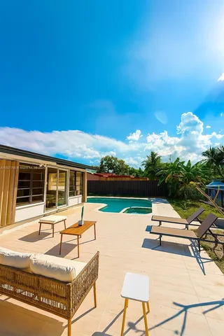 a swimming pool with outdoor seating and yard