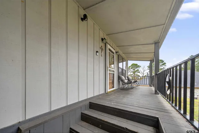 a room with stainless steel appliances kitchen island granite countertop furniture and a large window