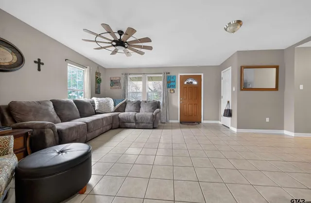 a bedroom with a bed and a dresser next to a window