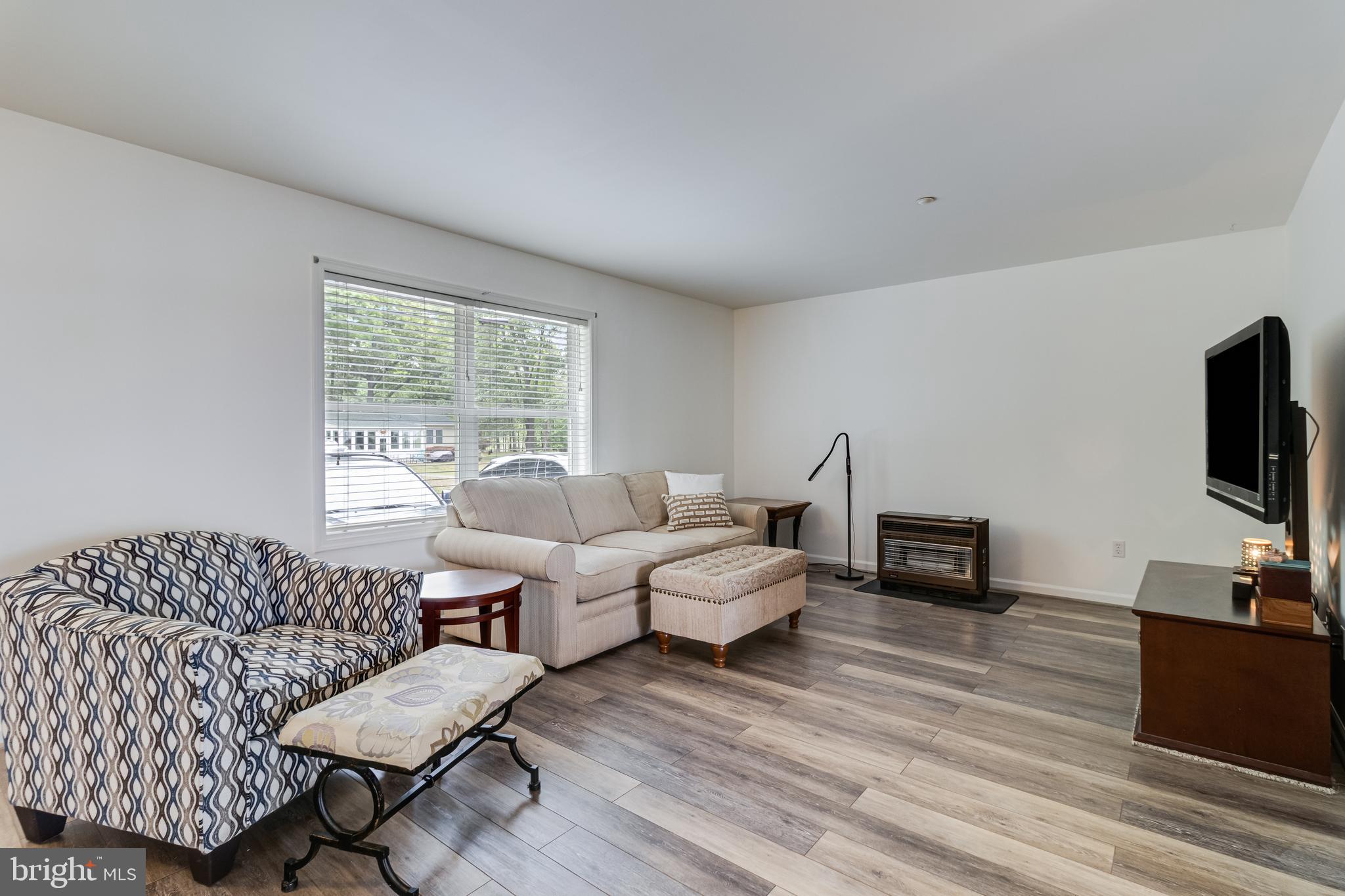 12015 Woodbury Road Nanjemoy, MD 20662 - Photo 6 of 53 a living room with furniture and a flat screen tv