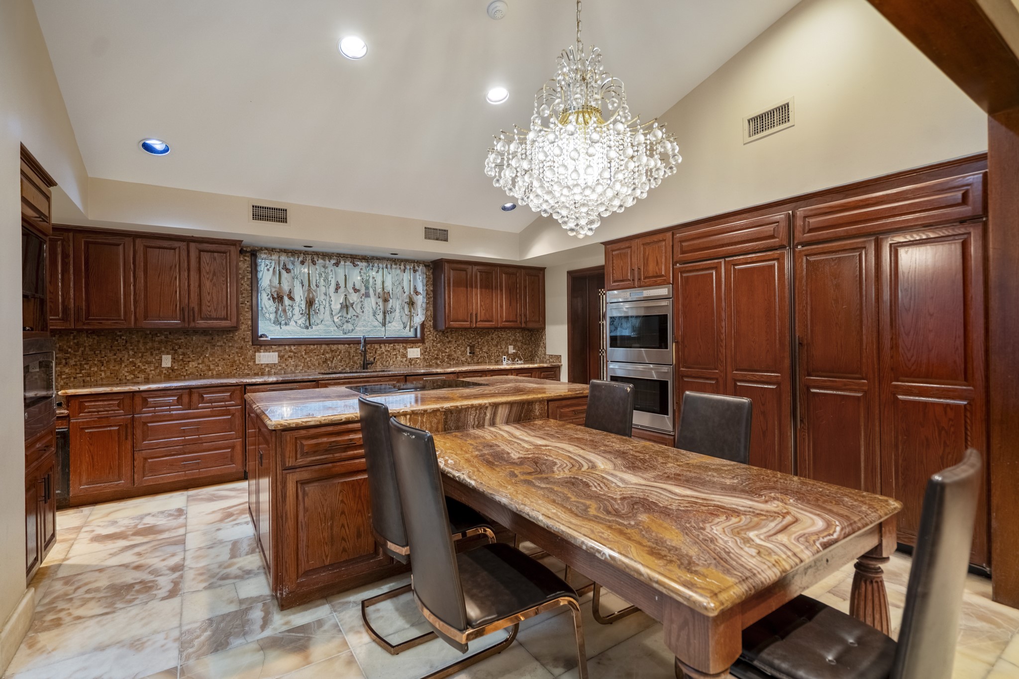 6535 Buffalo Speedway Houston, TX 77005 - Photo 13 of 40 Warm wood tones, handcrafted cabinetry, and expansive counters define this chef’s kitchen. A beautiful space for everyday cooking and special occasions alike.