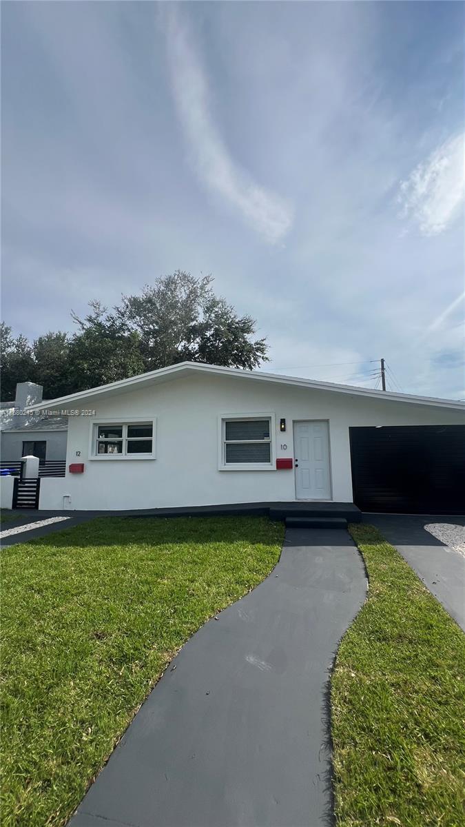 12 Northeast 49th Street, Unit 12 Miami, FL 33137 - Photo 1 of 13 a front view of a house with garden