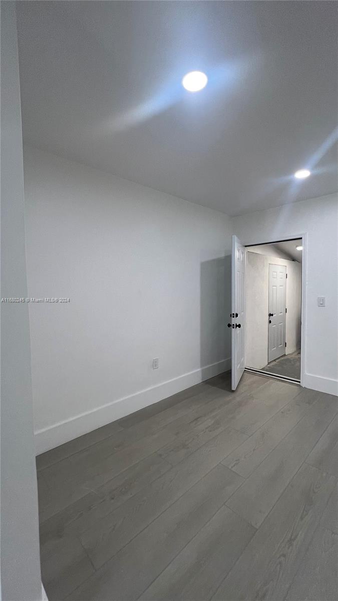 12 Northeast 49th Street, Unit 12 Miami, FL 33137 - Photo 10 of 13 an empty room with closet and windows