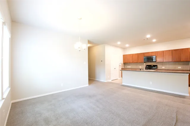 a view of kitchen with refrigerator sink and stove