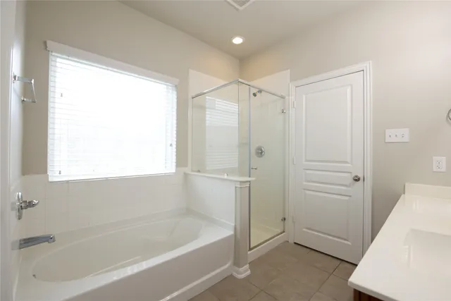 a bathroom with a bathtub and a shower