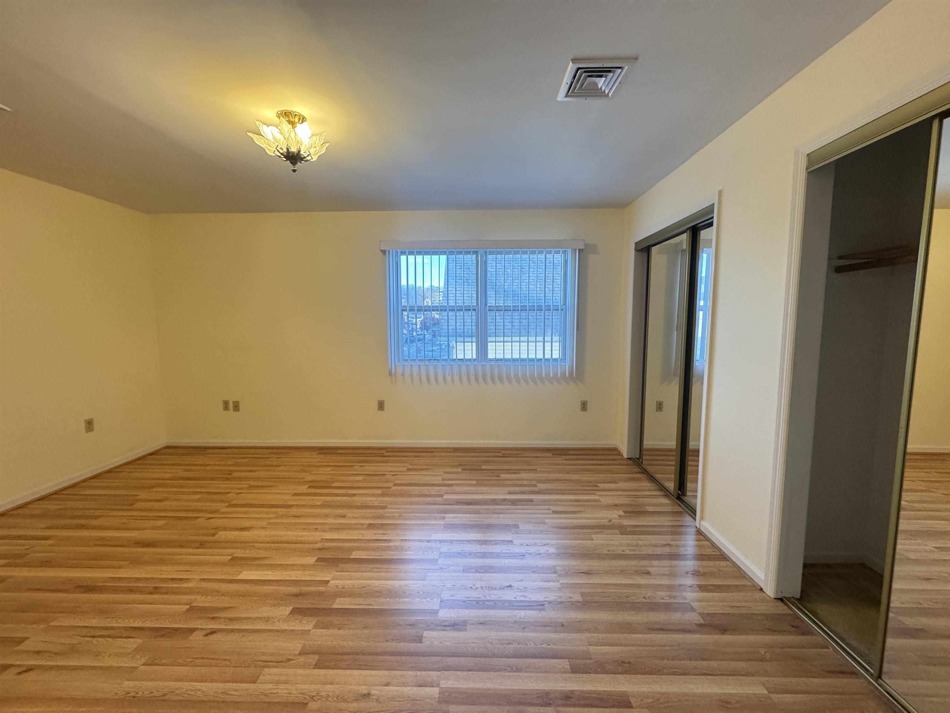 4414 Liberty Avenue, Unit 2 North Bergen, NJ 07047 - Photo 11 of 14 a view of an empty room with window and wooden floor