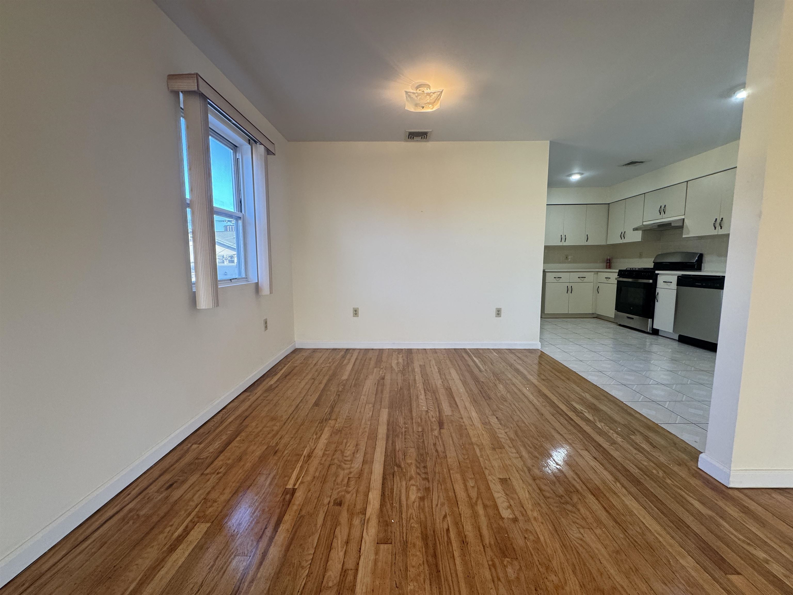 4414 Liberty Avenue, Unit 2 North Bergen, NJ 07047 - Photo 4 of 14 a view of a room with wooden floor and electronic appliances