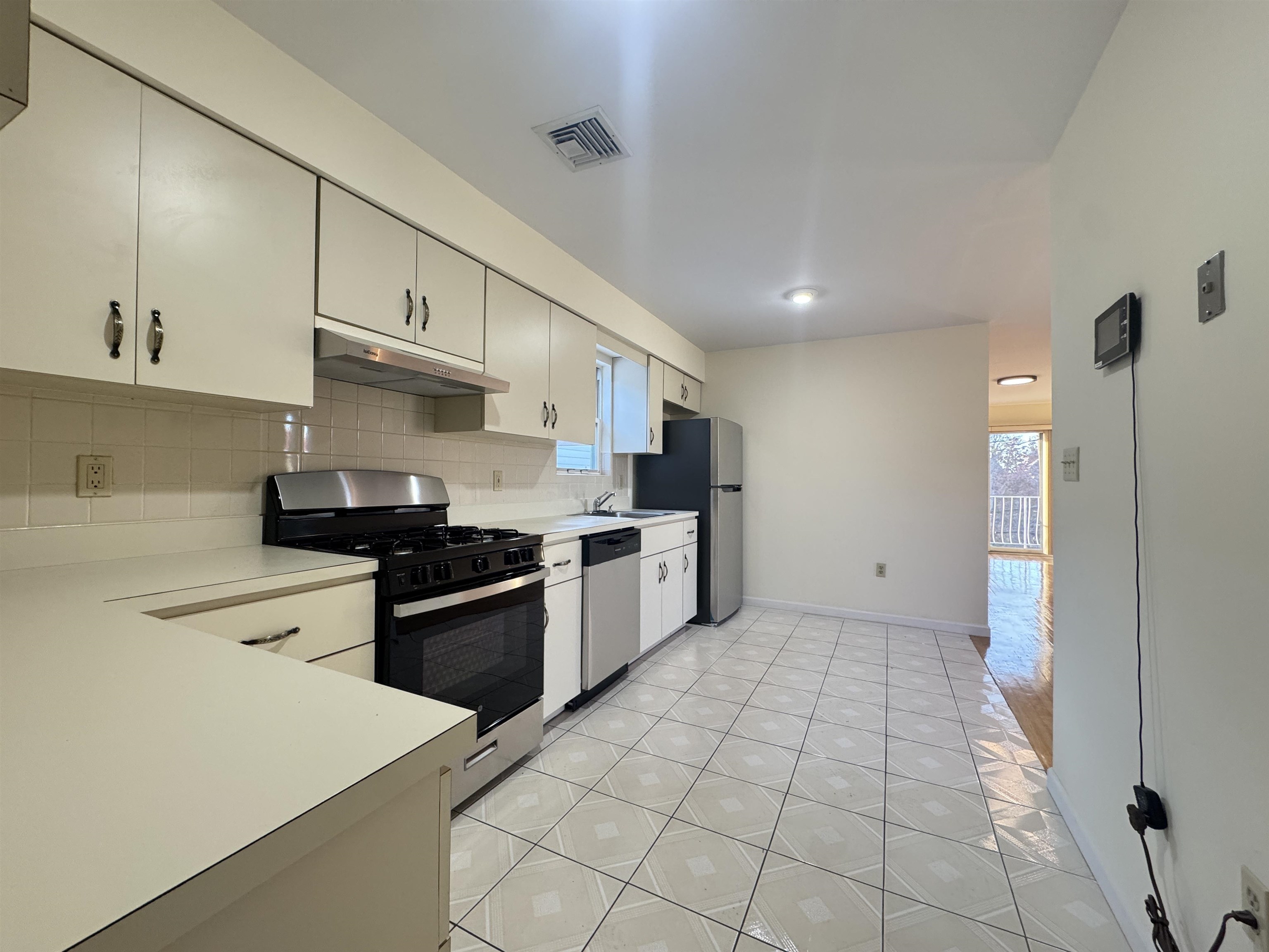 4414 Liberty Avenue, Unit 2 North Bergen, NJ 07047 - Photo 6 of 14 a kitchen with stainless steel appliances granite countertop a sink and a stove
