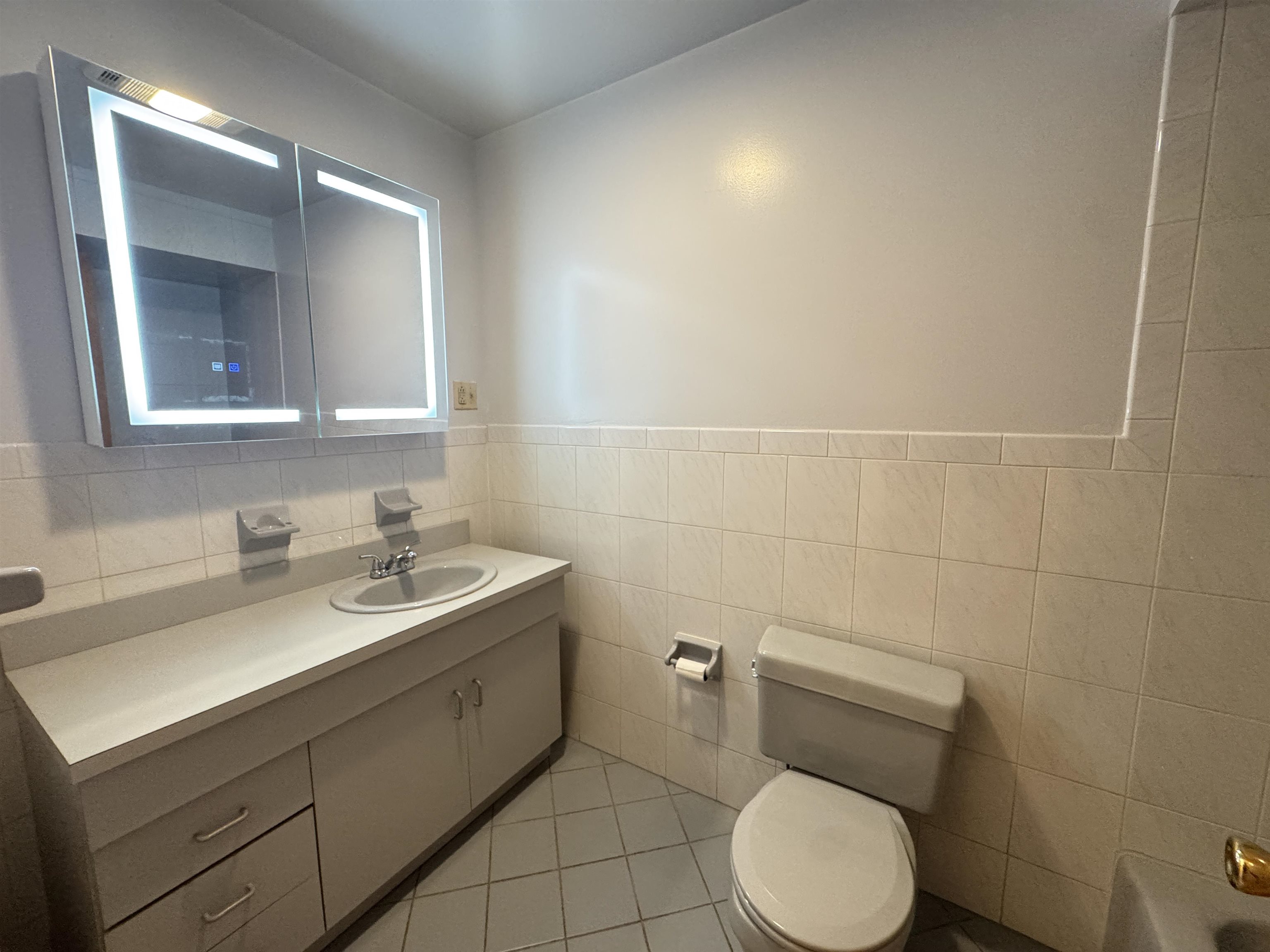 4414 Liberty Avenue, Unit 2 North Bergen, NJ 07047 - Photo 10 of 14 a bathroom with a toilet sink and mirror