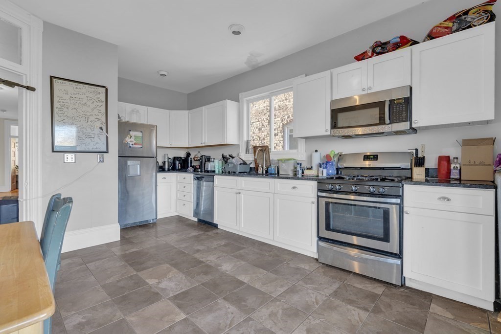 100 Calumet Street Boston, MA 02120 - Photo 12 of 42 a kitchen with stainless steel appliances granite countertop a refrigerator sink stove and microwave