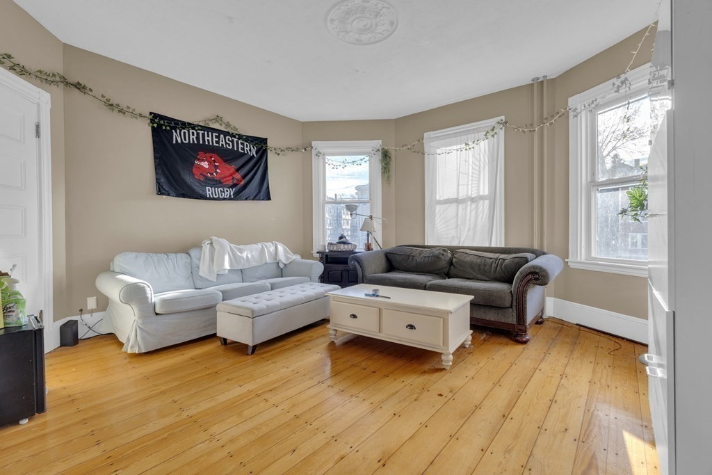 100 Calumet Street Boston, MA 02120 - Photo 13 of 42 a living room with furniture and a wooden floor