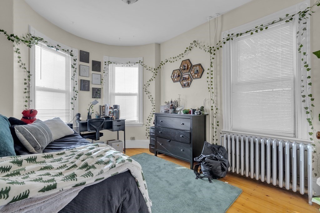 100 Calumet Street Boston, MA 02120 - Photo 15 of 42 a bedroom with a bed and a window