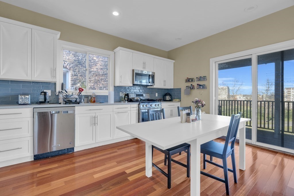 100 Calumet Street Boston, MA 02120 - Photo 19 of 42 a kitchen with a dining table chairs and sink