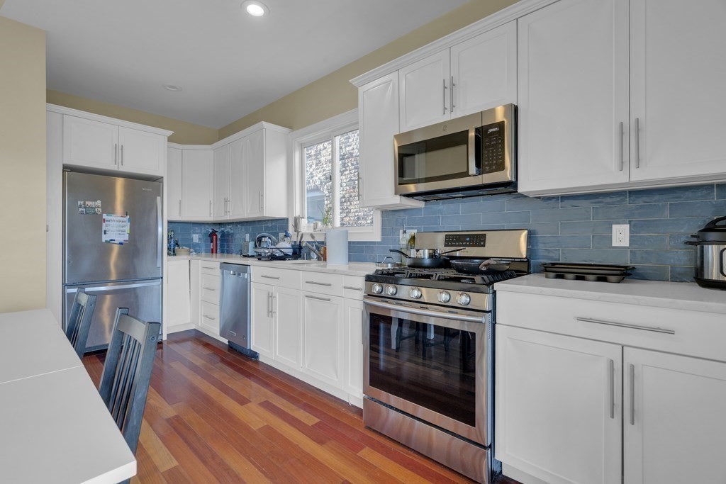 100 Calumet Street Boston, MA 02120 - Photo 20 of 42 a kitchen with granite countertop white cabinets and stainless steel appliances