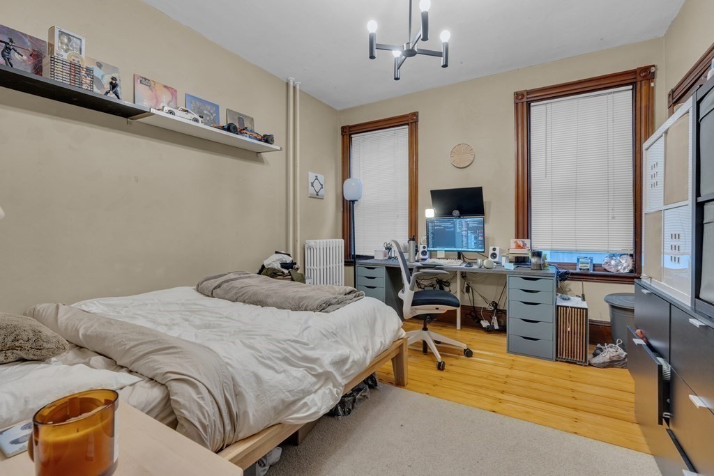100 Calumet Street Boston, MA 02120 - Photo 22 of 42 a bedroom with a bed couch and a window