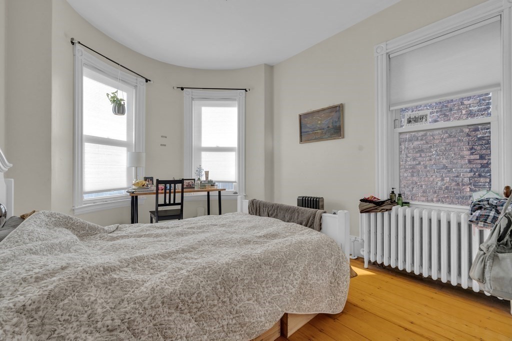 100 Calumet Street Boston, MA 02120 - Photo 24 of 42 a bedroom with a bed and a table with lamp