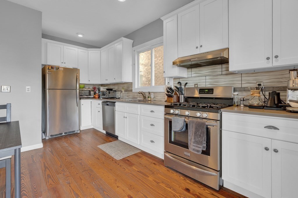 100 Calumet Street Boston, MA 02120 - Photo 3 of 42 a kitchen with granite countertop a refrigerator stove top oven and cabinets