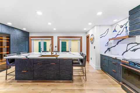 a view of a kitchen counter space and wooden floor