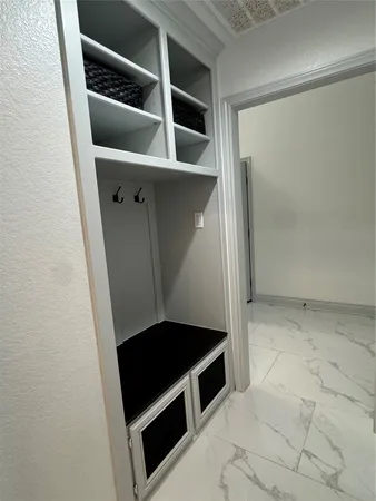 a view of a hallway with wooden floor and entryway